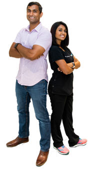 image of tom and jenny, the founders standing back to back with arms crossed smiling