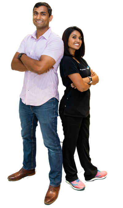 image of tom and jenny, the founders standing back to back with arms crossed smiling