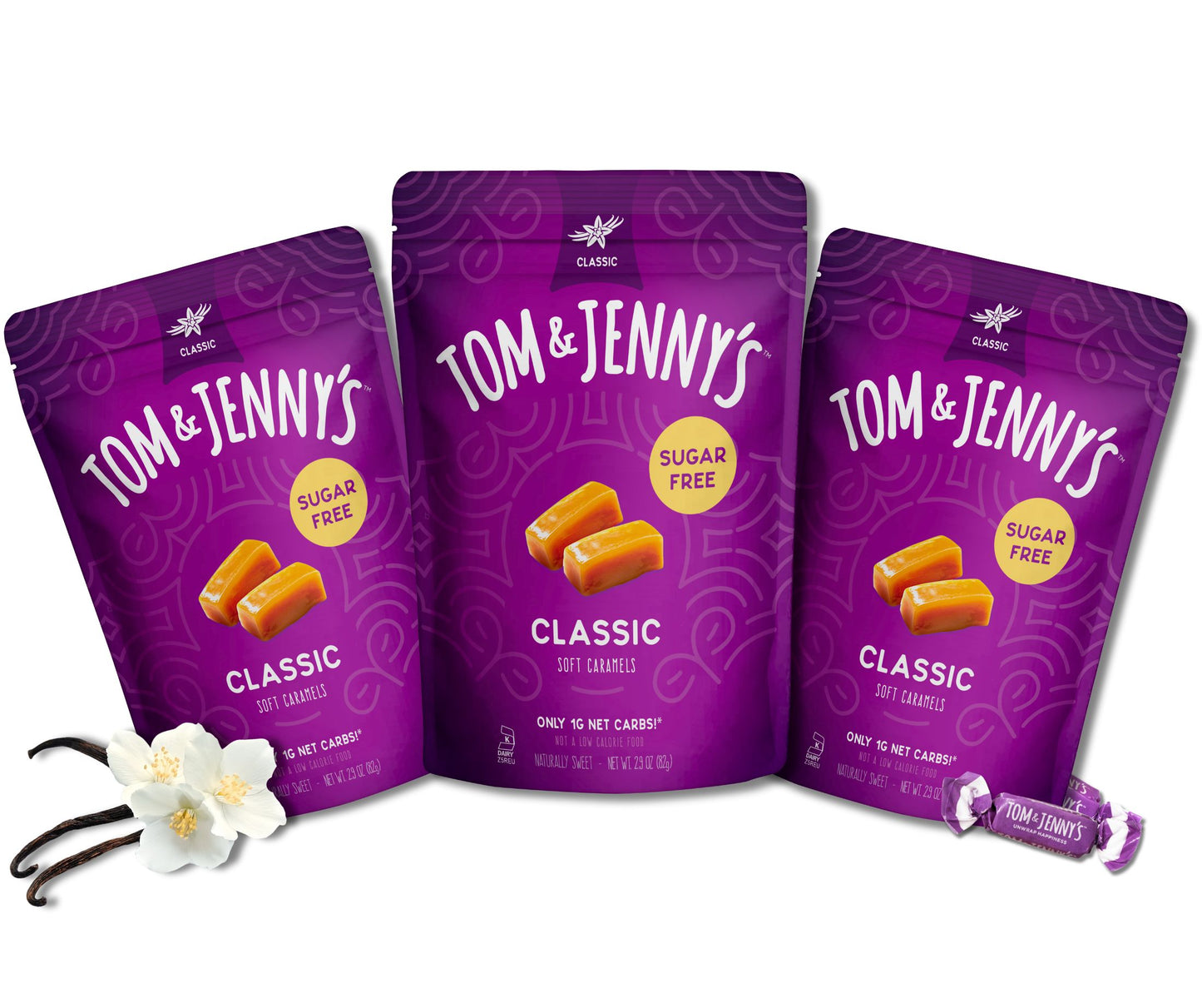Three packages of Tom & Jenny's classic soft caramels on a white background with vanilla beans in the bottom left