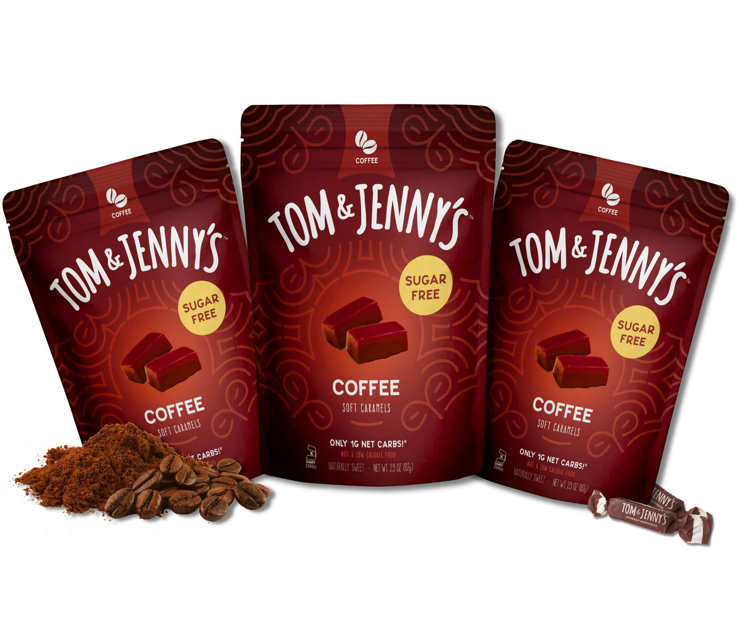 Three packages of Tom & Jenny's coffee soft caramels on a white background with coffee beans and grounds in the bottom left