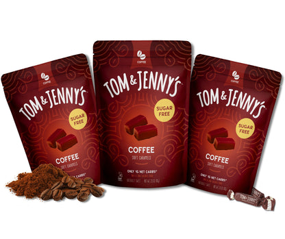 Three packages of Tom & Jenny's coffee soft caramels on a white background with coffee beans and grounds in the bottom left