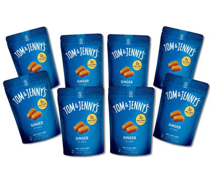 Eight blue stand-up pouches of Tom & Jenny's Ginger caramels arranged on a plain white background.