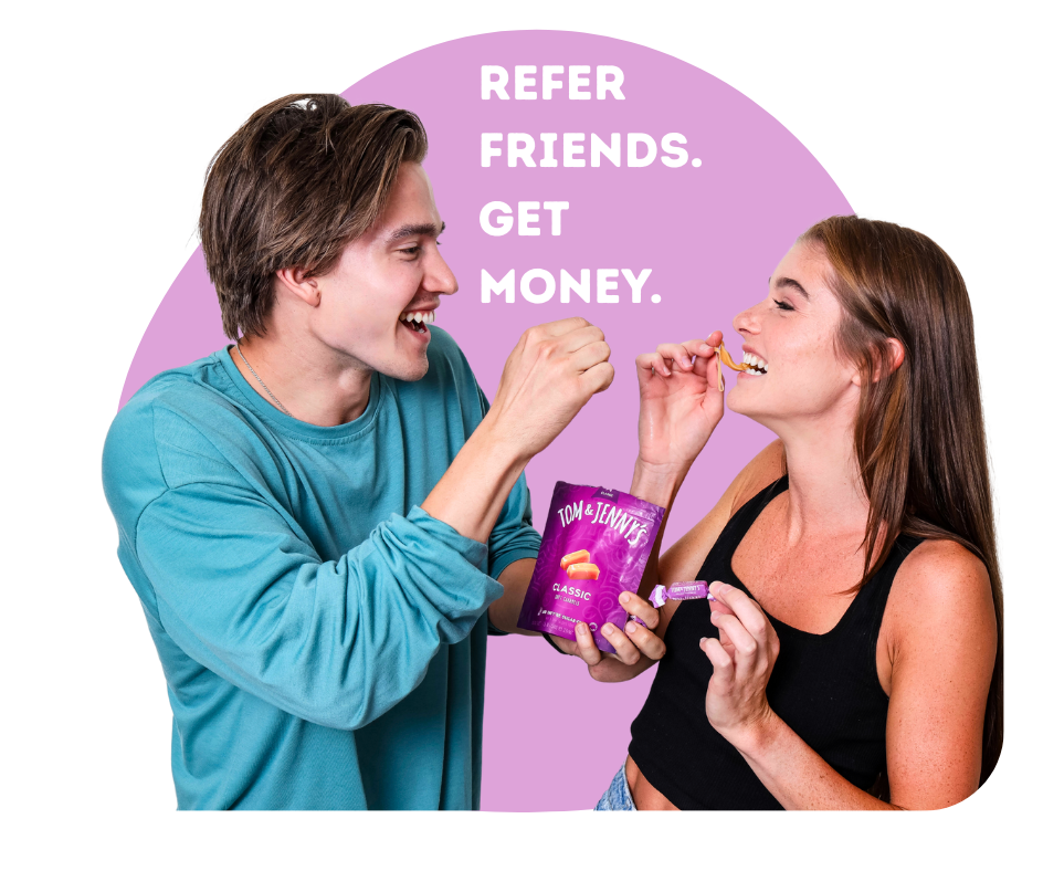 Image of two people sharing Classic Tom & Jenny's caramels with the phrase "Refer Friends. Get Money." nearby