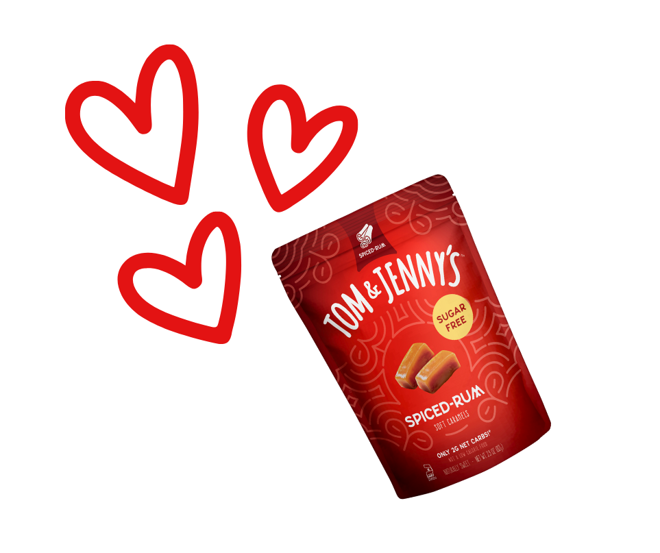 Image of a bag of Spiced Rum Tom & Jenny's and three red outlines of hearts near the bag's top-left