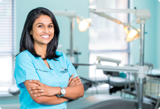 Jenny in scrubs smiling in her dental clinic