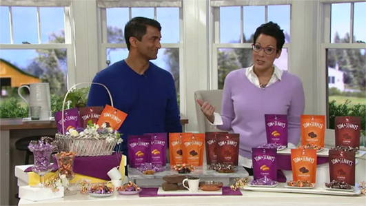 Tom discussing caramels on television with TV host 